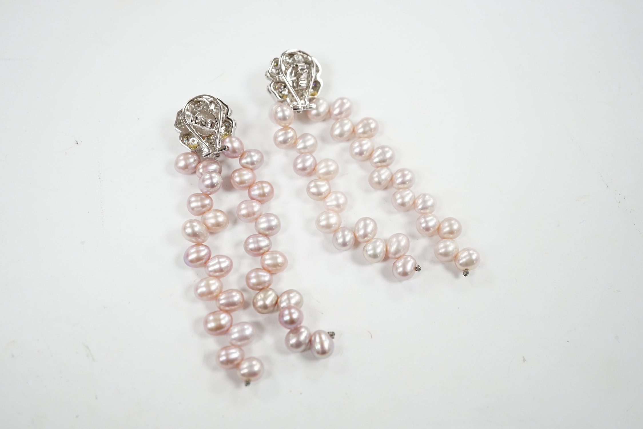 A modern pair of white metal, diamond chip cluster and three row pink cultured pearl tassel drop earrings, 91mm.